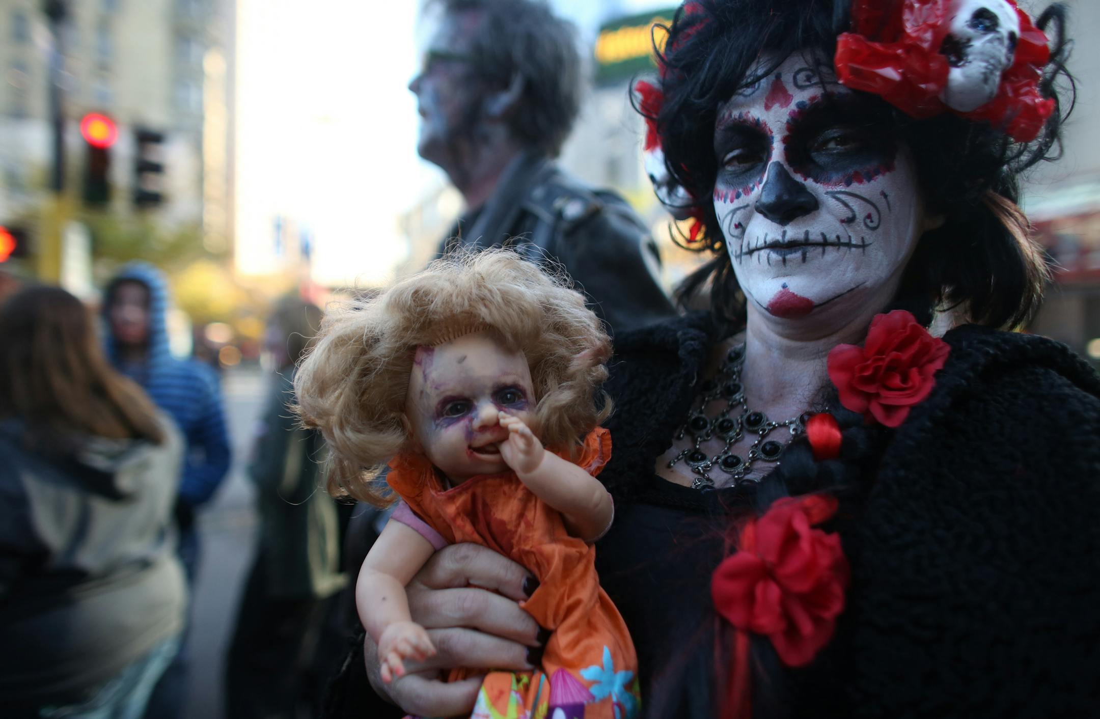 Maria D'Angelo, of Cottage Grove, showed off her baby doll that was a part of her costume while waiting to head into the Zombie Pub Crawl. ] (KYNDELL HARKNESS/STAR TRIBUNE) kyndell.harkness@startribune.com Zombie Pub Crawl in Minneapolis, Min., Saturday October 17, 2015.