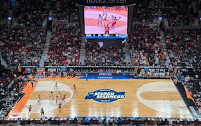 Texas players defend as North Carolina State players pass the ball during the second half of Sunday's Elite Eight game at the Moda Center in Portland,