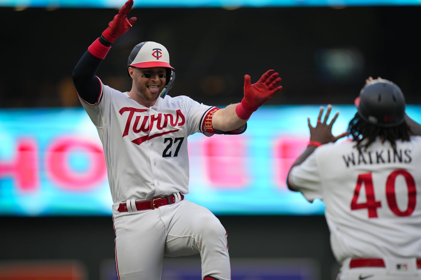 Minnesota Twins catcher Ryan Jeffers (27) celebrates with third base coach Tommy Watkins (40) after hitting a home run in the second inning against the Arizona Diamondbacks at Target Field.