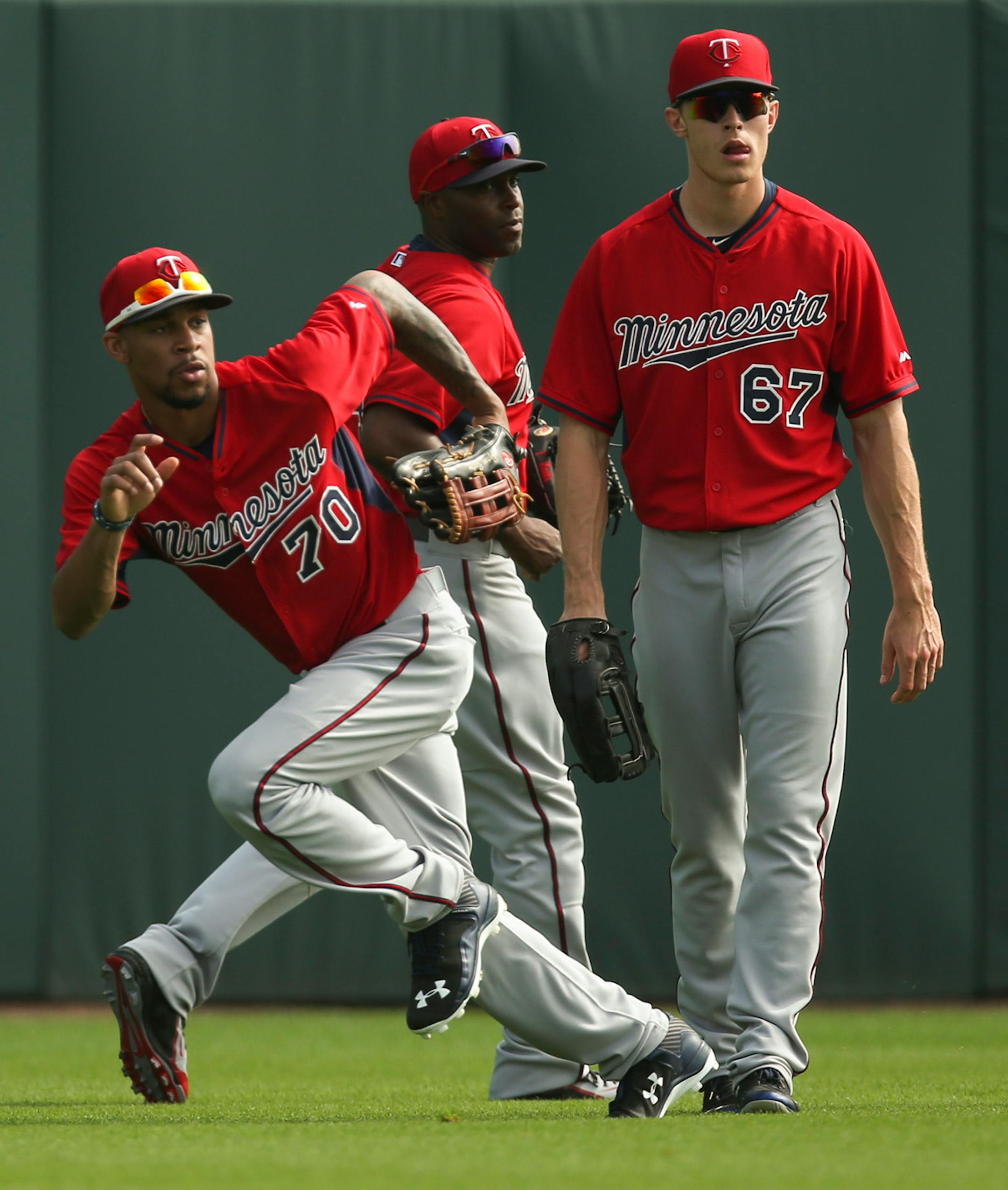 Minnesota Twins center fielder Byron Buxton sprinted for a ball during a fielding drill for outfielders Saturday morning at Hammond Stadium. Behind him were Torii Hunter and Max Kepler, right.
