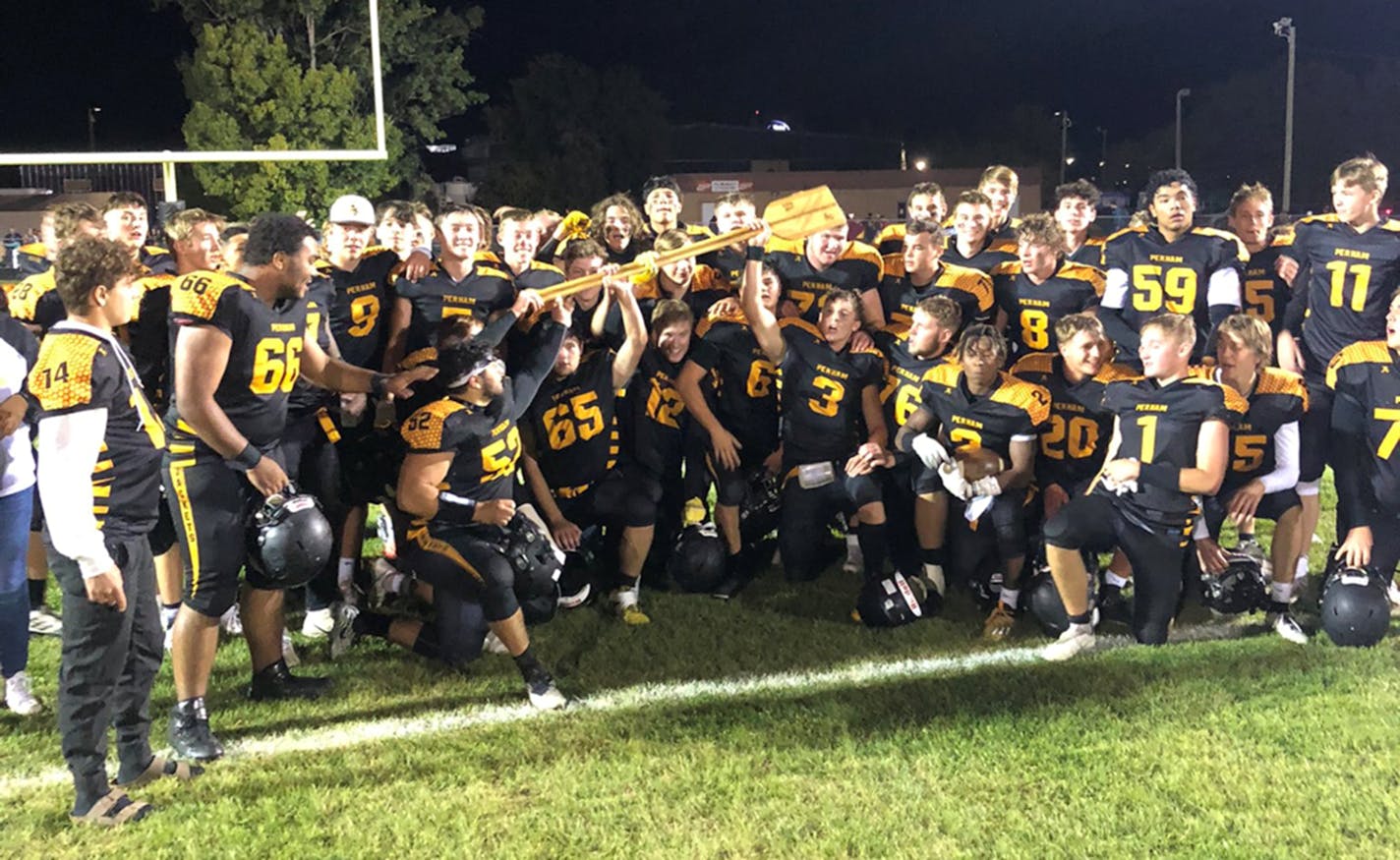 Here is a photo to go with an item I'm writing tomorrow about Perham's team. They pulled off a trick play – hook and ladder – with 30 seconds left to beat their biggest rival Detroit Lakes and win the traveling trophy – the canoe paddle in this picture. I talked to the quarterback and two receivers who ran the play to perfection.