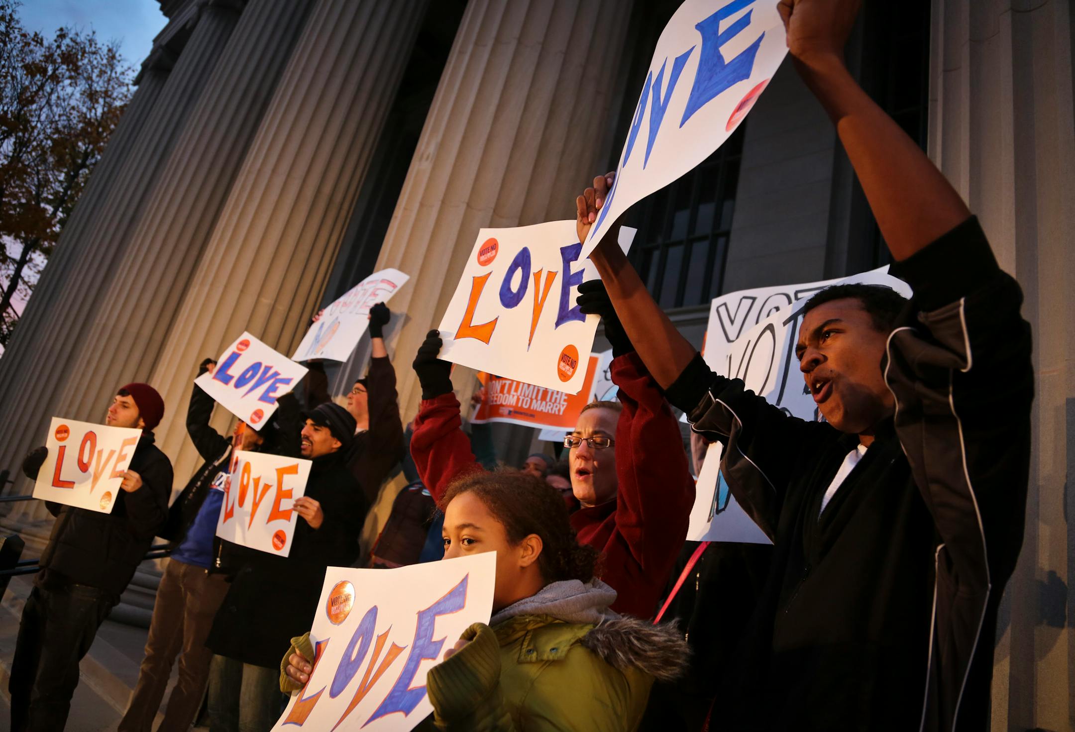 People held sign as they gathered in opposition of the Marriage Amendment at the University of Minnesota Campus on October 29.