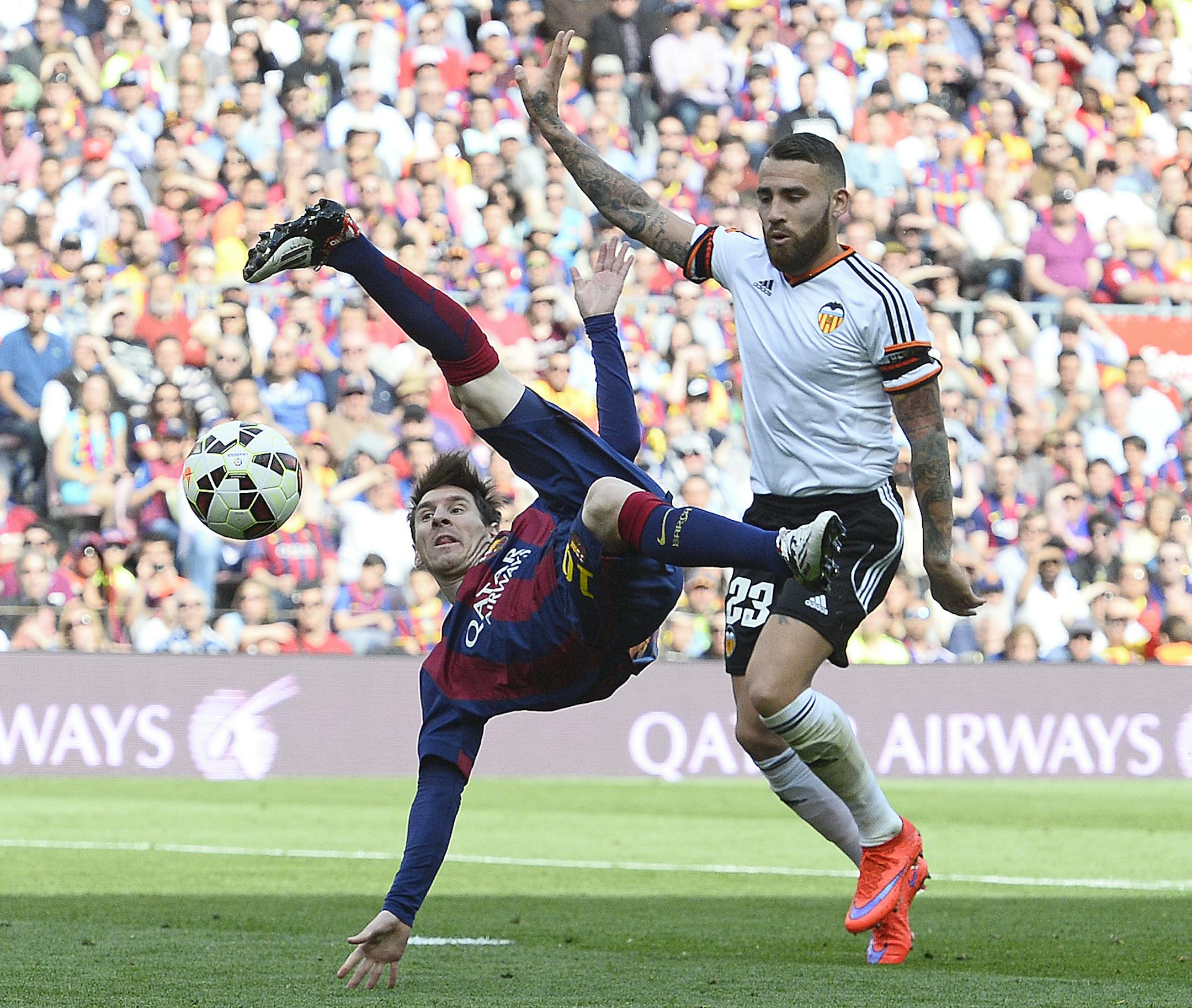 FC Barcelona's Lionel Messi, left, duels for the ball against Valencia's Nicolas Otamendi during a Spanish La Liga soccer match at the Camp Nou stadium in Barcelona, Spain, Saturday, April 18, 2015. (AP Photo/Manu Fernandez) ORG XMIT: MF108