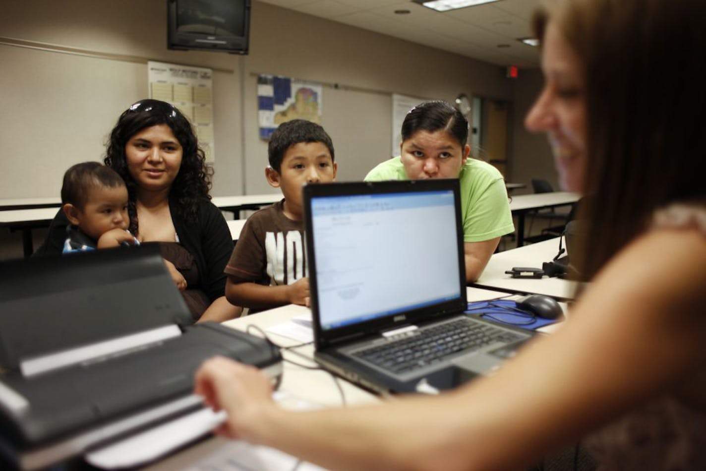 Nurse Jennifer Doble completes the health background survey with Dalila Ruiz's family before their checkup.