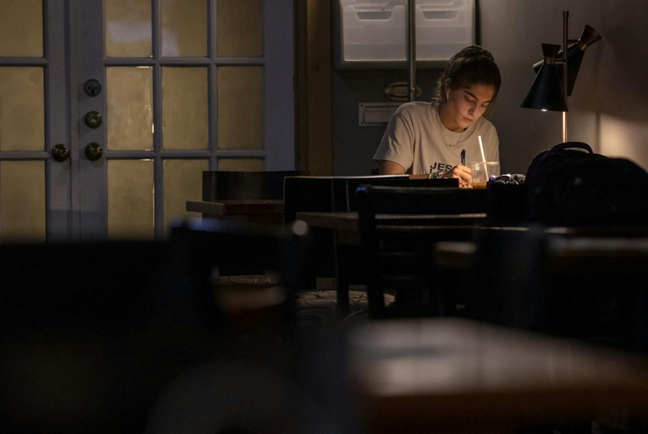 Haley Ronayne, 20, a Sophomore at Winona State University sat next to light at Blooming Grounds Coffee House.