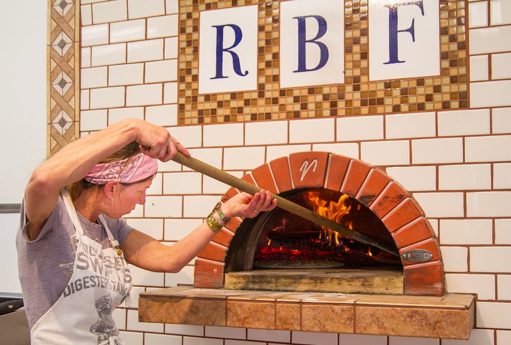 Red Barn Farm has been serving up pies since 2012. Here, co-owner Tammy Winter tends to pizzas in the wood-burning oven in 2015.