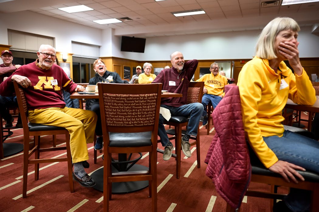 Booster club members laugh along with Gophers players while they answered questions during a panel on March 4 at Williams Arena.