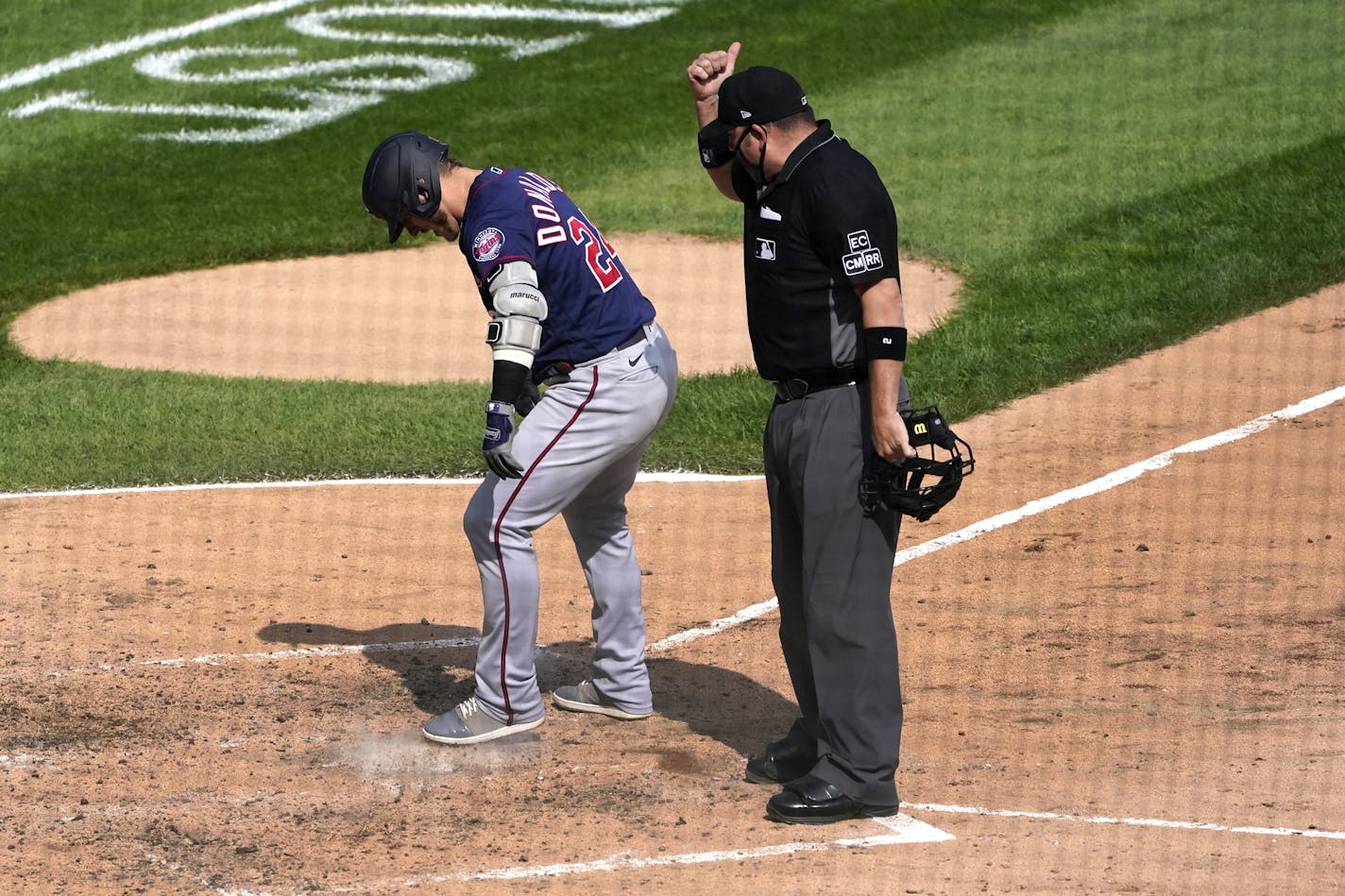 Minnesota Twins' Josh Donaldson kicks dirt on home plate after his home run prompting umpire Dan Bellino to eject him from the game during the sixth inning of a baseball game against the Chicago White Sox Thursday, Sept. 17, 2020, in Chicago. (AP Photo/Charles Rex Arbogast)