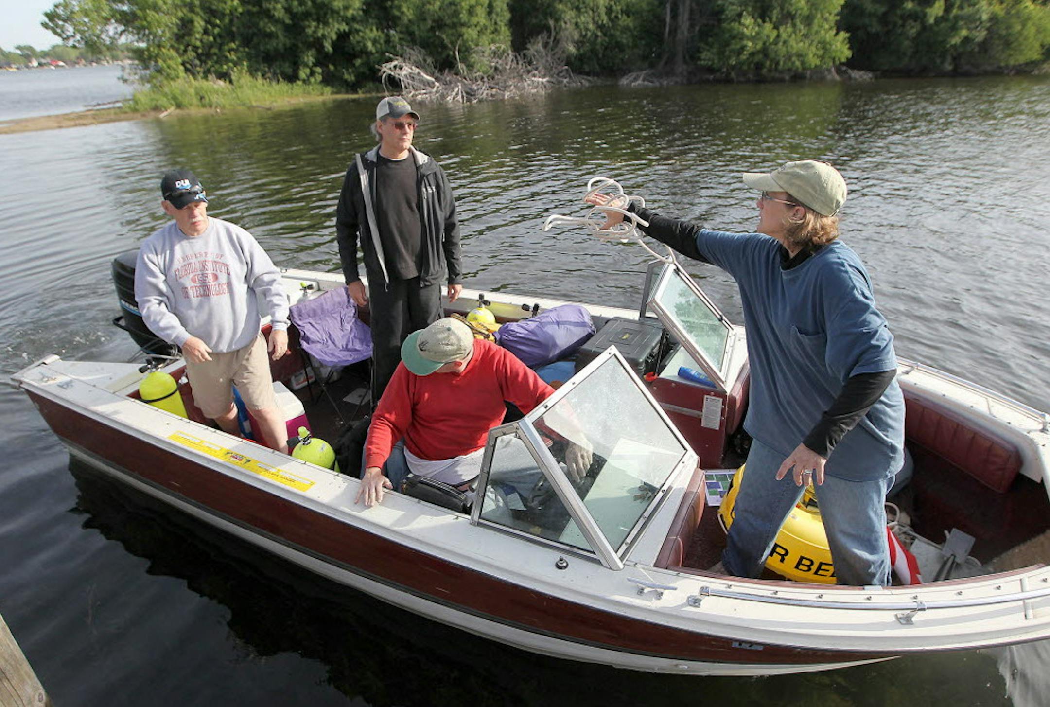 Kelly Nehowig, from left, Mark Slick, Chris Olson, and Ann Merriman load up to prepare for a dive into Lake Minnetonka on June 2, 2015. They are diving to investigate and help identify shipwrecks this summer.