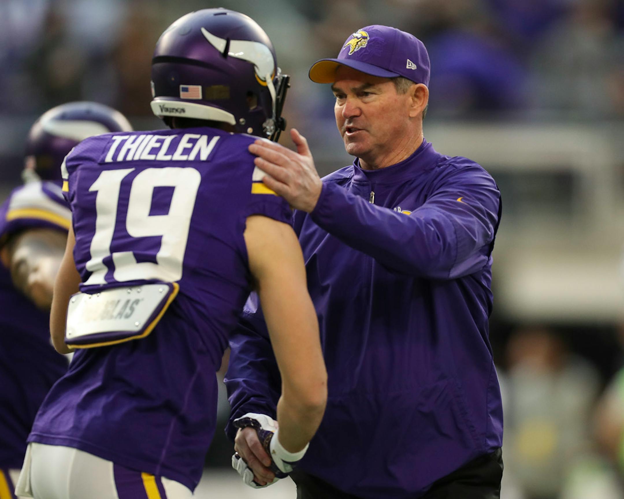 Vikings head coach Mike Zimmer shook hands with Vikings wide receiver Adam Thielen as players stretched before Sunday's game. Thielen is only 40 yards short of a 1000 yard season, the first for a Vikings receiver since 2009.