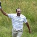Shawn Stefani acknowledges the gallery after hitting a hole in one on the 17th hole during the fourth round of the U.S. Open golf tournament at Merion