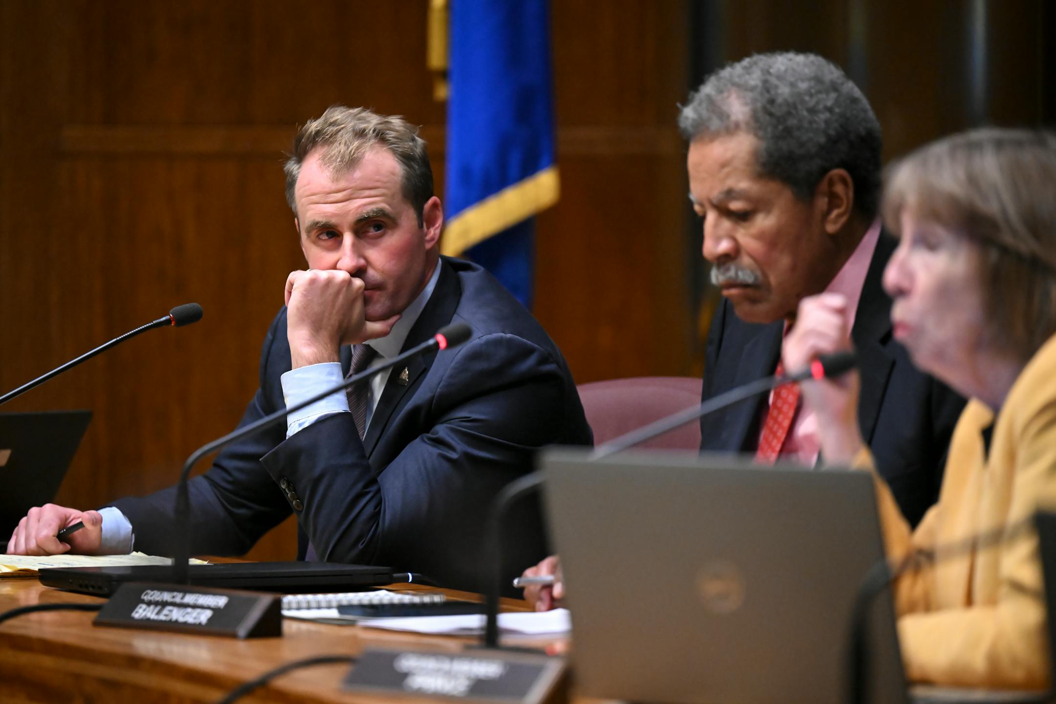 Council member Chris Tolbert listens to fellow council member Jane Prince.