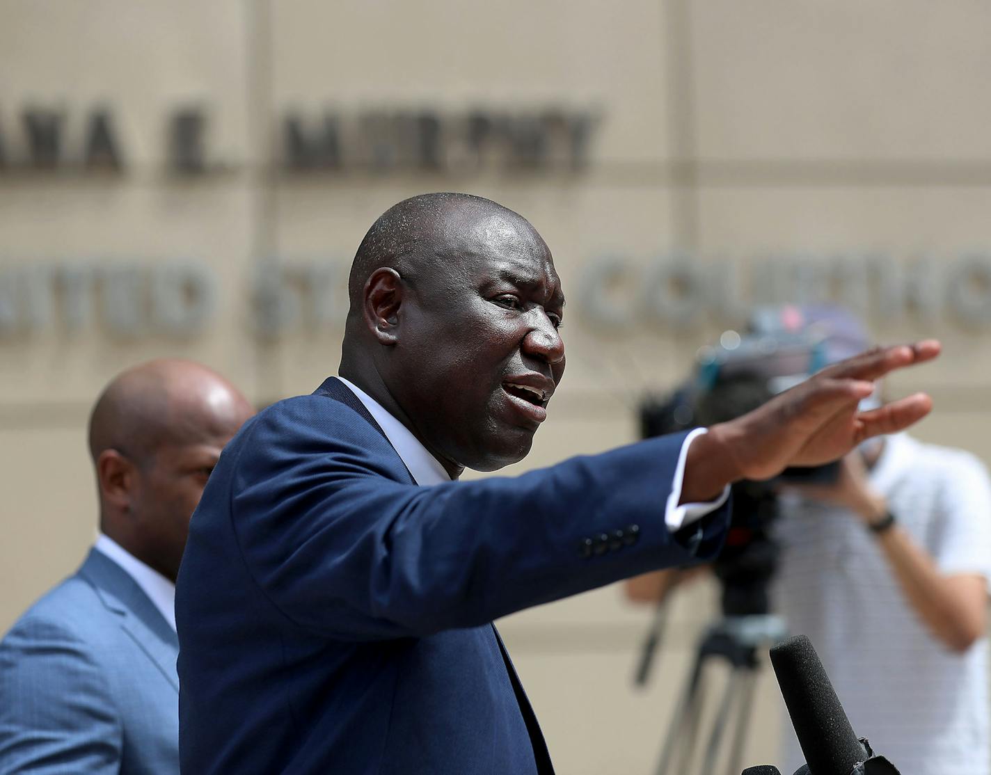 Attorney Ben Crump, who represents George Floyd's family, announces in a news conference that the family of Floyd is suing the city of Minneapolis and the four officers involved in his death, citing a failure in proper police training and a racist departmental culture that led to a "reckless disregard" of Floyd's civil rights Wednesday, July 15, 2020, outside the U.S. Federal Courthouse in Minneapolis. Here, Crump is seen at the podium surrounded by his team of lawyers. (David Joles/Minneapolis