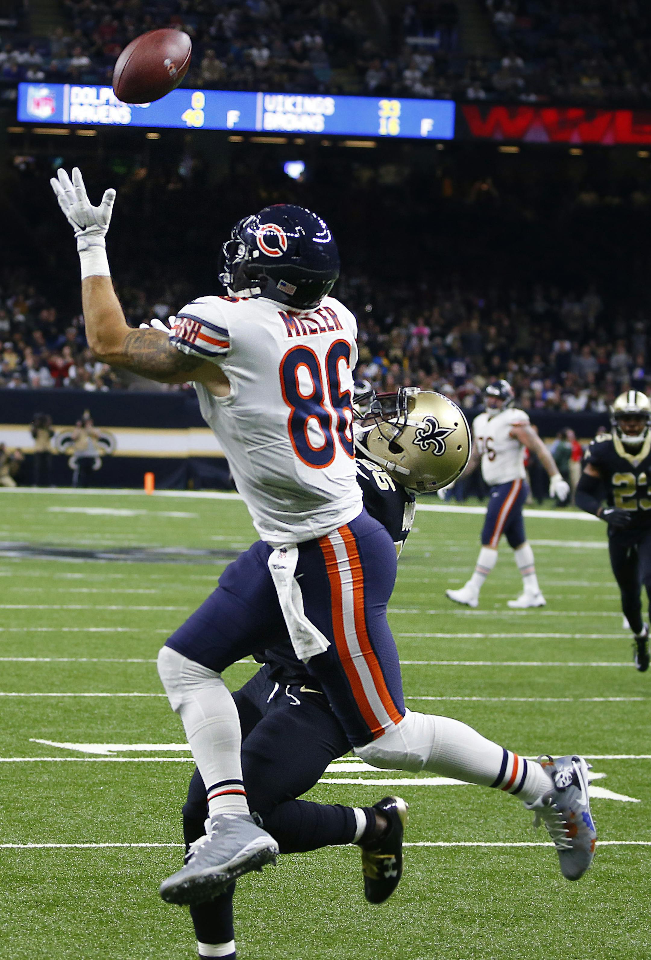 Chicago Bears tight end Zach Miller (86) pulls in a touchdown reception, that was ruled incomplete upon review, as New Orleans Saints defensive back Rafael Bush (25) covers, in the second half of an NFL football game in New Orleans, Sunday, Oct. 29, 2017. Miller injured his leg on the play and was carted off the field. (AP Photo/Butch Dill)