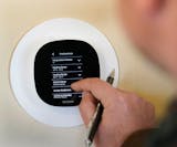 Center for Energy & Environment HVAC consultant Taylor Smith sets a programable thermostat Oct. 13, 2022 in Minneapolis. DAVID JOLES • david.joles@s