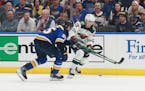 Minnesota Wild's Matt Boldy (12) works the puck against St. Louis Blues' Colton Parayko (55) during the first period in Game 6 of an NHL hockey Stanle