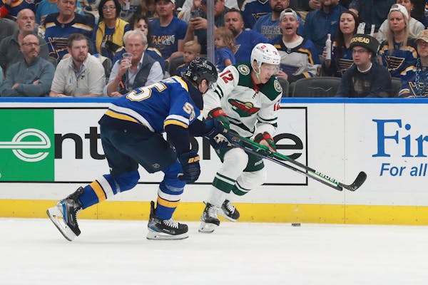 Minnesota Wild's Matt Boldy (12) works the puck against St. Louis Blues' Colton Parayko (55) during the first period in Game 6 of an NHL hockey Stanle
