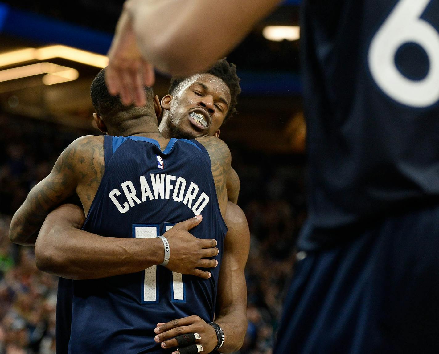 Wolves star Jimmy Butler, celebrating here after a win with Jamal Crawford, is among league leaders in minutes played this season — leading to moans from many fans — as he plays at what coach Tom Thibodeau declared "an MVP level."