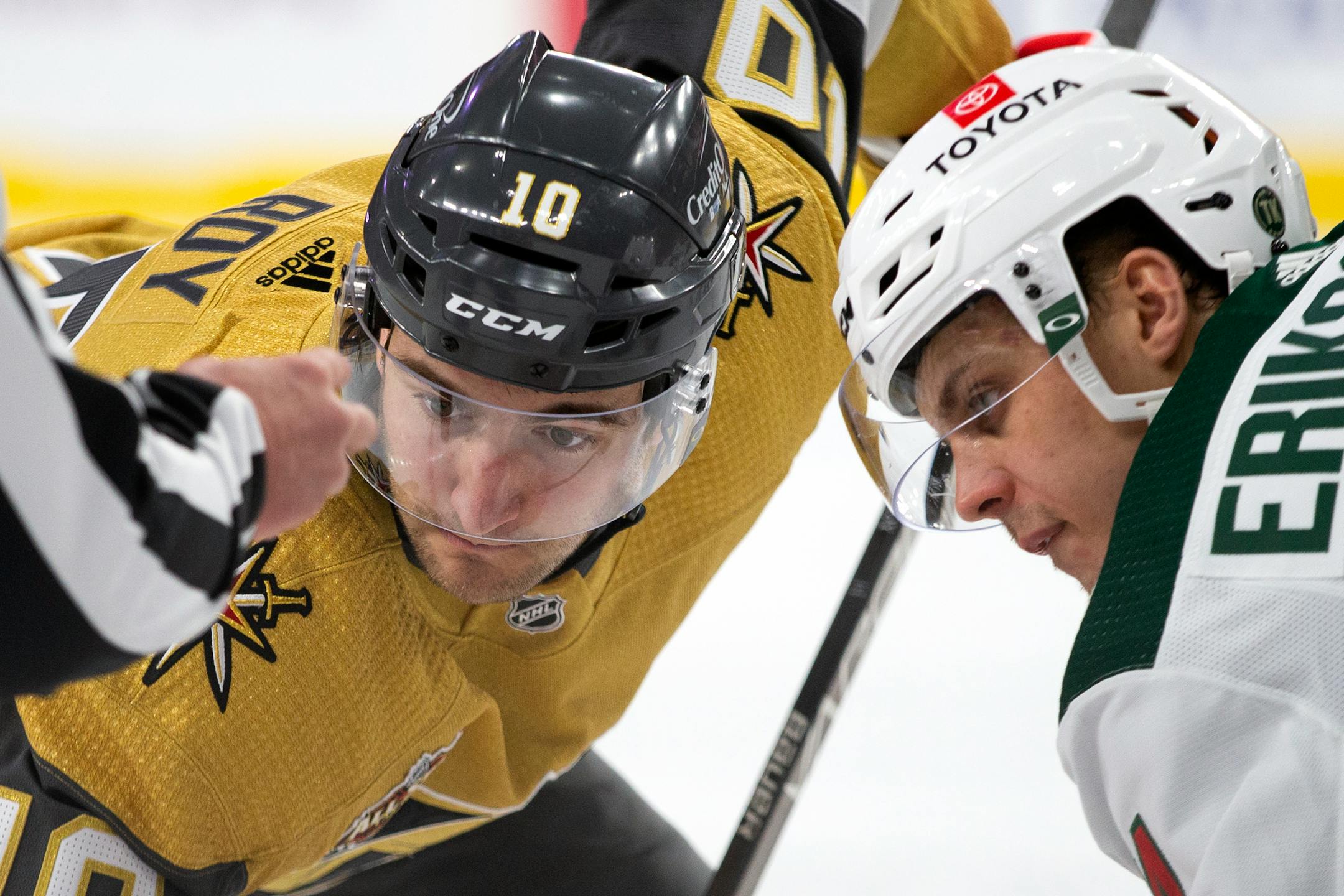 Vegas Golden Knights center Nicolas Roy (10) and Minnesota Wild center Joel Eriksson Ek, right, face off during the second period of an NHL hockey game Sunday, Dec. 12, 2021, in Las Vegas. (AP Photo/Ellen Schmidt)