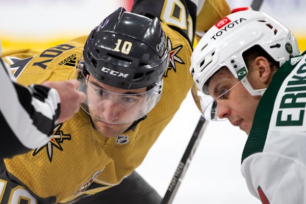 Vegas Golden Knights center Nicolas Roy (10) and Minnesota Wild center Joel Eriksson Ek, right, face off during the second period of an NHL hockey gam