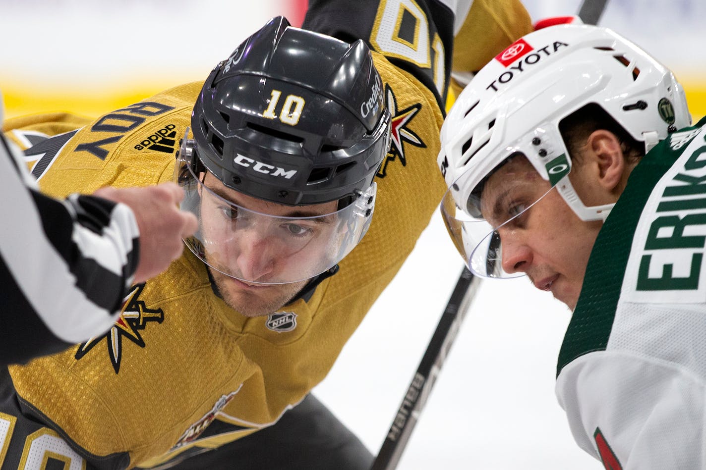 Vegas Golden Knights center Nicolas Roy (10) and Minnesota Wild center Joel Eriksson Ek, right, face off during the second period of an NHL hockey game Sunday, Dec. 12, 2021, in Las Vegas. (AP Photo/Ellen Schmidt)