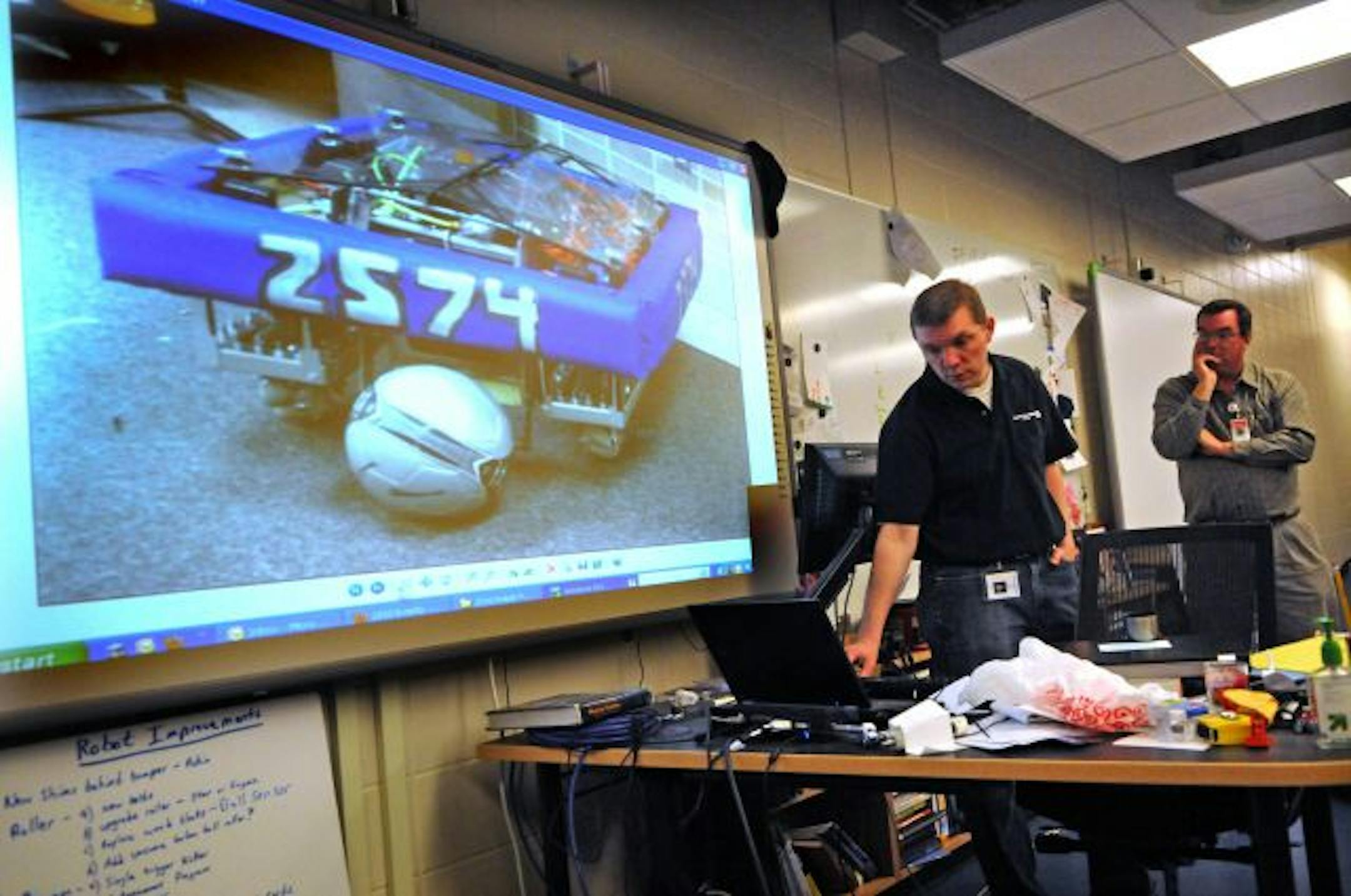 U.S. First Robotics Challenge lead teacher Paul Lulai and Eric Bollenson, an engineer from Onan Corp., have helped the St. Anthony High School team design and build a soccer-playing robot that they hope will win a national championship in Atlanta later this month.