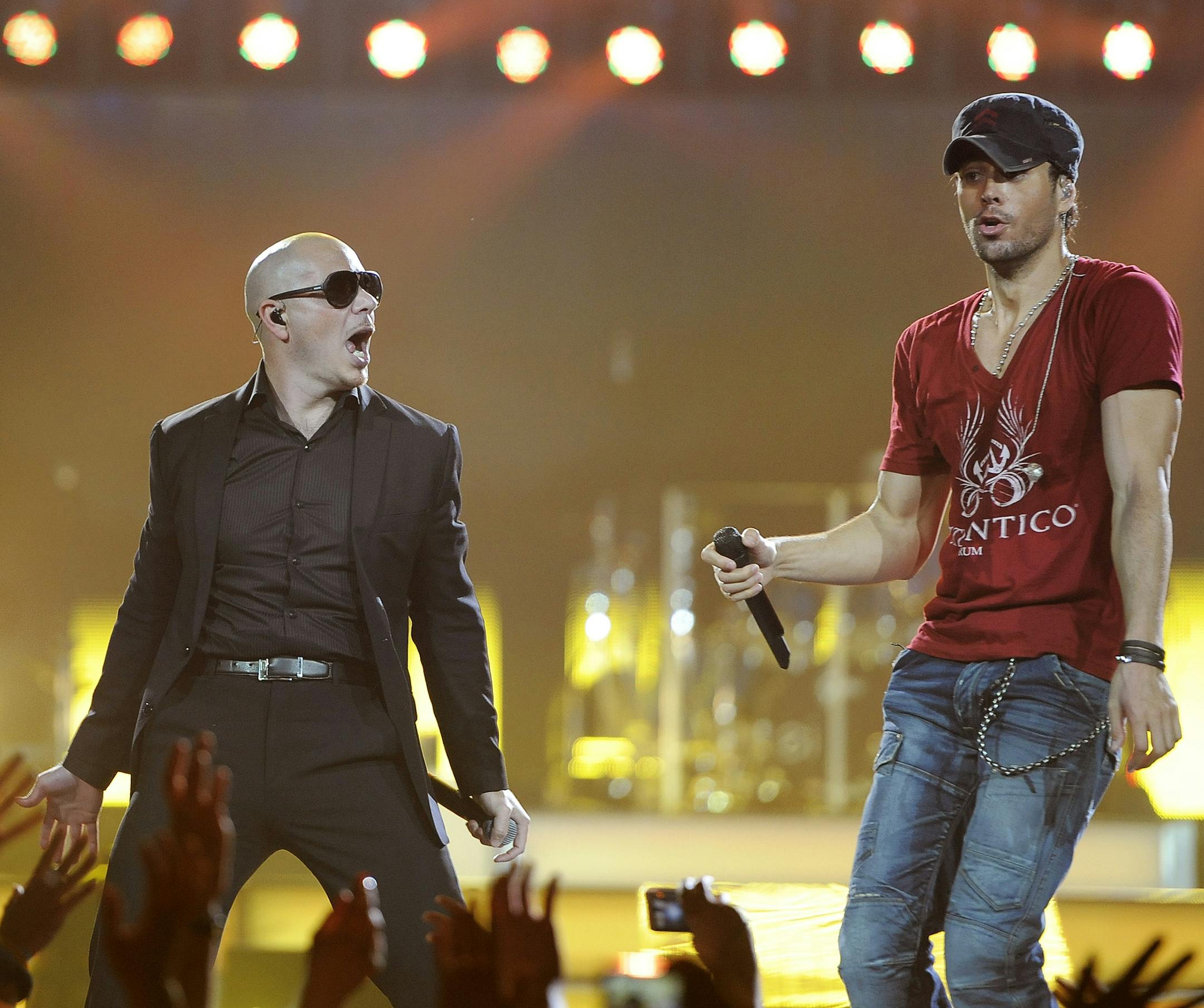 Enrique Iglesias, right, is joined onstage by guest performer Pitbull at the Honda Center on Saturday, Aug. 11, 2012 in Anaheim, Calif. (Photo by Chris Pizzello/Invision/AP) ORG XMIT: INVW