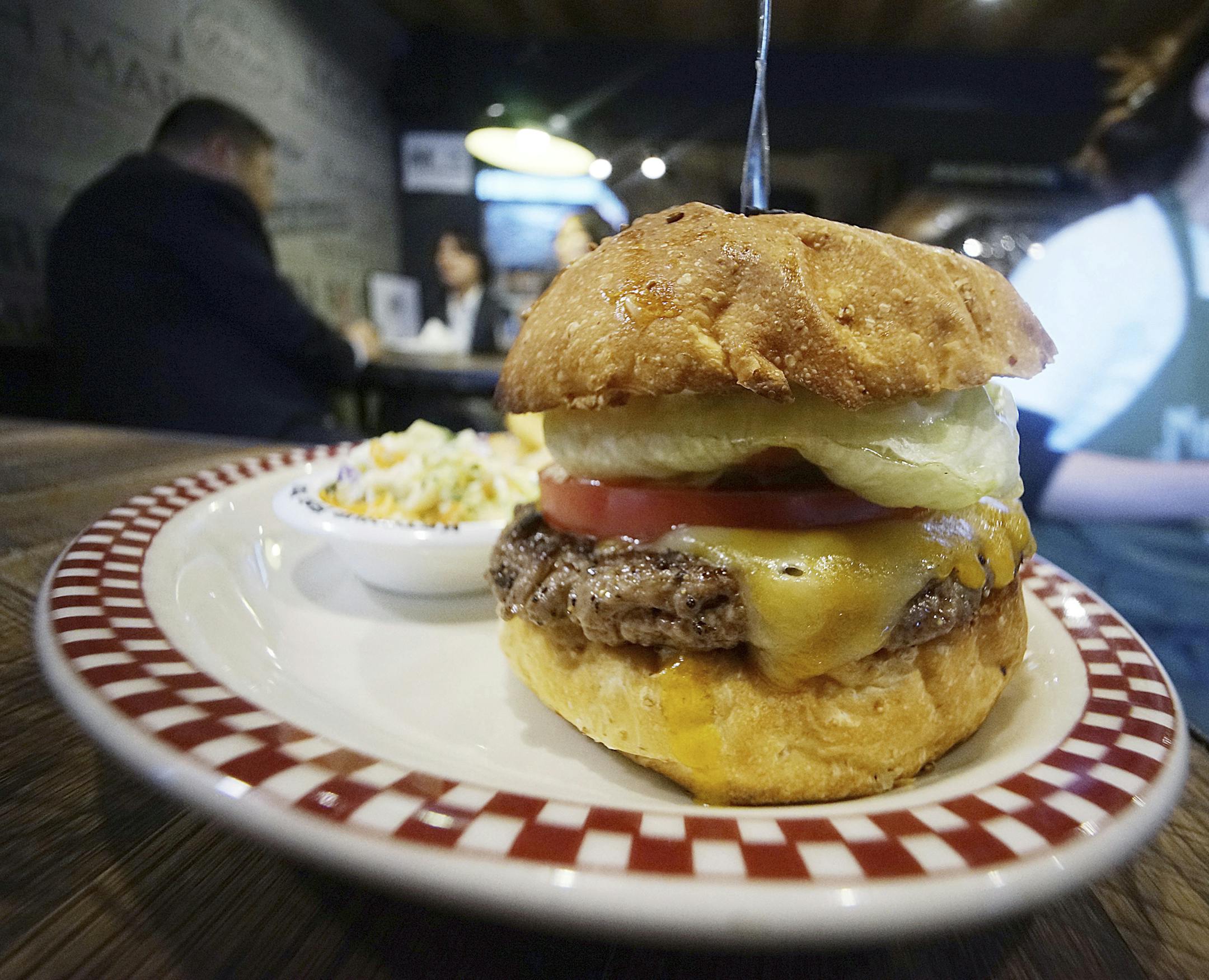 A 100 percent U.S. Angus beef Colby Jack Cheeseburger as part of U.S. President Donald Trump set is seen at Munch's Burger Shack restaurant in Tokyo Thursday, Nov. 16, 2017. The cheeseburger Trump had during his recent visit to Japan is still drawing lines at the Tokyo burger joint. (AP Photo/Eugene Hoshiko)
