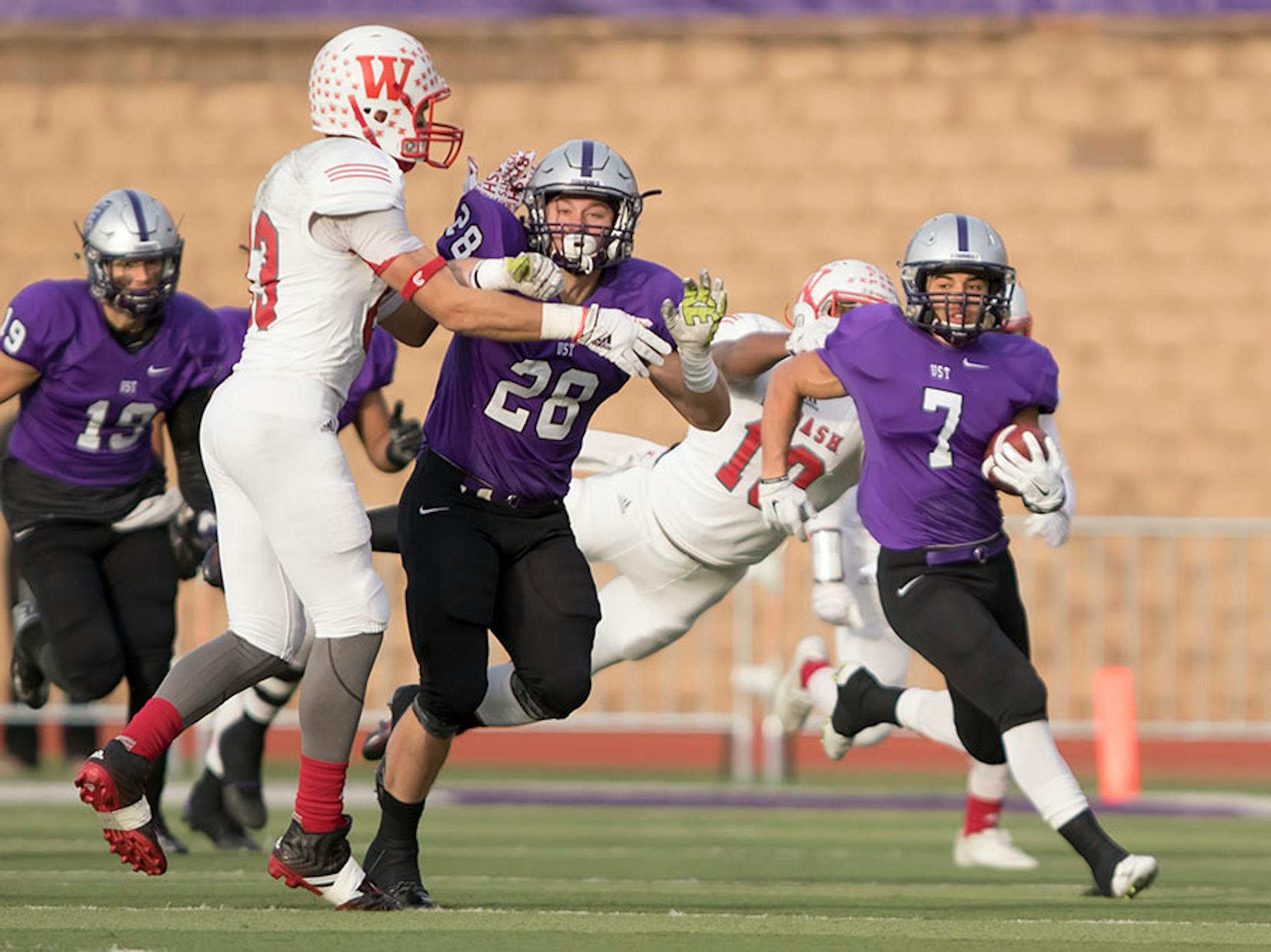 St. Thomas defensive back Joe Reed (7) runs with the ball behind the blocking of St. Thomas running back Tucker Trettel (28) as the University of St. Thomas Tommies hosted the Wabash College Little Giants on December 5, 2015.