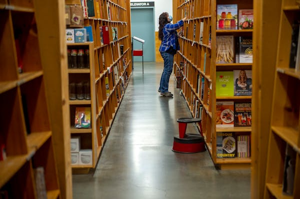 A shopper at the flagship Powell's Books store in Portland, Oregon, on Nov. 2, 2021. Like the rest of Portland's urban core ' and like downtowns acros