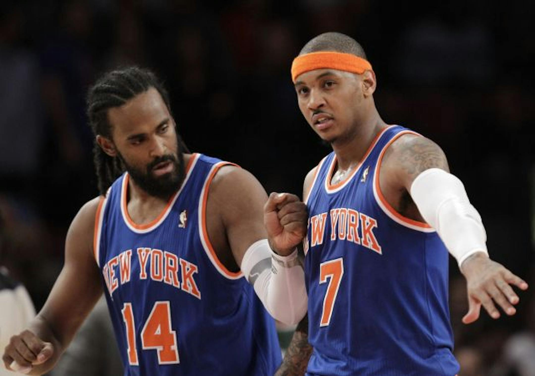 New York Knicks center Ronny Turiaf (14) congratulates forward Carmelo Anthony (7) near the end of the Knicks' 114-108 victory over the Milwaukee Bucks in an NBA basketball game at Madison Square Garden in New York, Wednesday, Feb. 23, 2011.