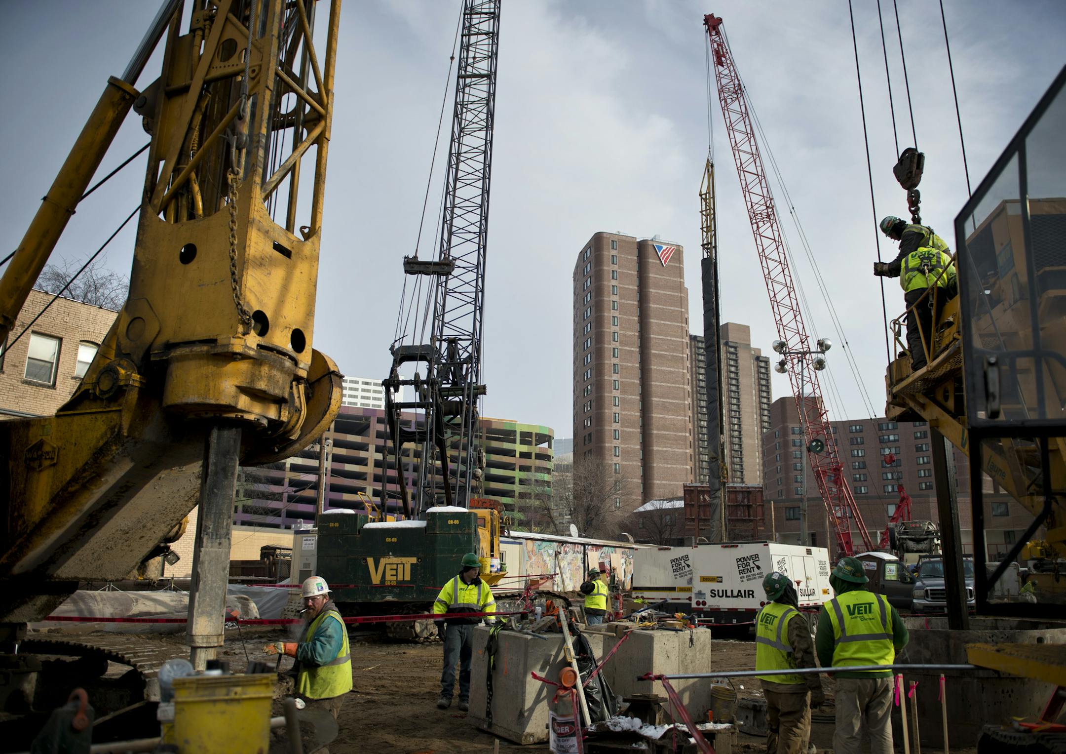 Workers from Veit Construction drilled holes for foundation supports Friday, December 14, 2012 at what will become a 36-story apartment building near Loring Park in Minneapolis. ] GLEN STUBBE * gstubbe@startribune.com ORG XMIT: MIN1212141602140499