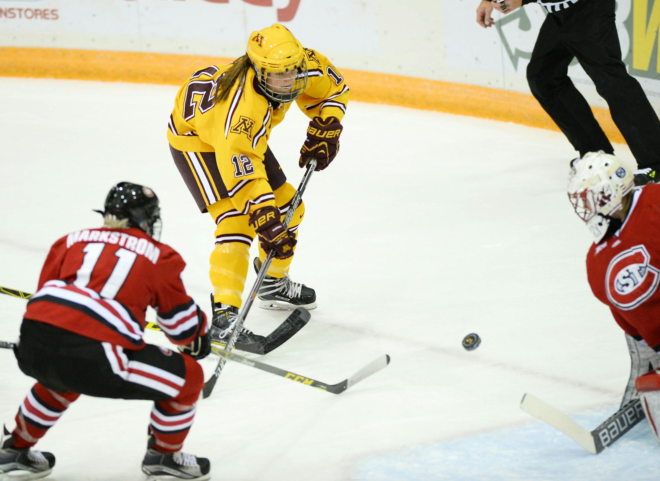 University of Minnesota defender Megan Wolfe (12) attempted a shot against St. Cloud University goalie Katie Fitzgerald during the first period Friday night. ] Aaron Lavinsky • aaron.lavinsky@startribune.com The University of Minnesota Golden Gophers women's hockey team played the St. Cloud State University Huskies on Friday, Oct. 9, 2015 at Ridder Arena.