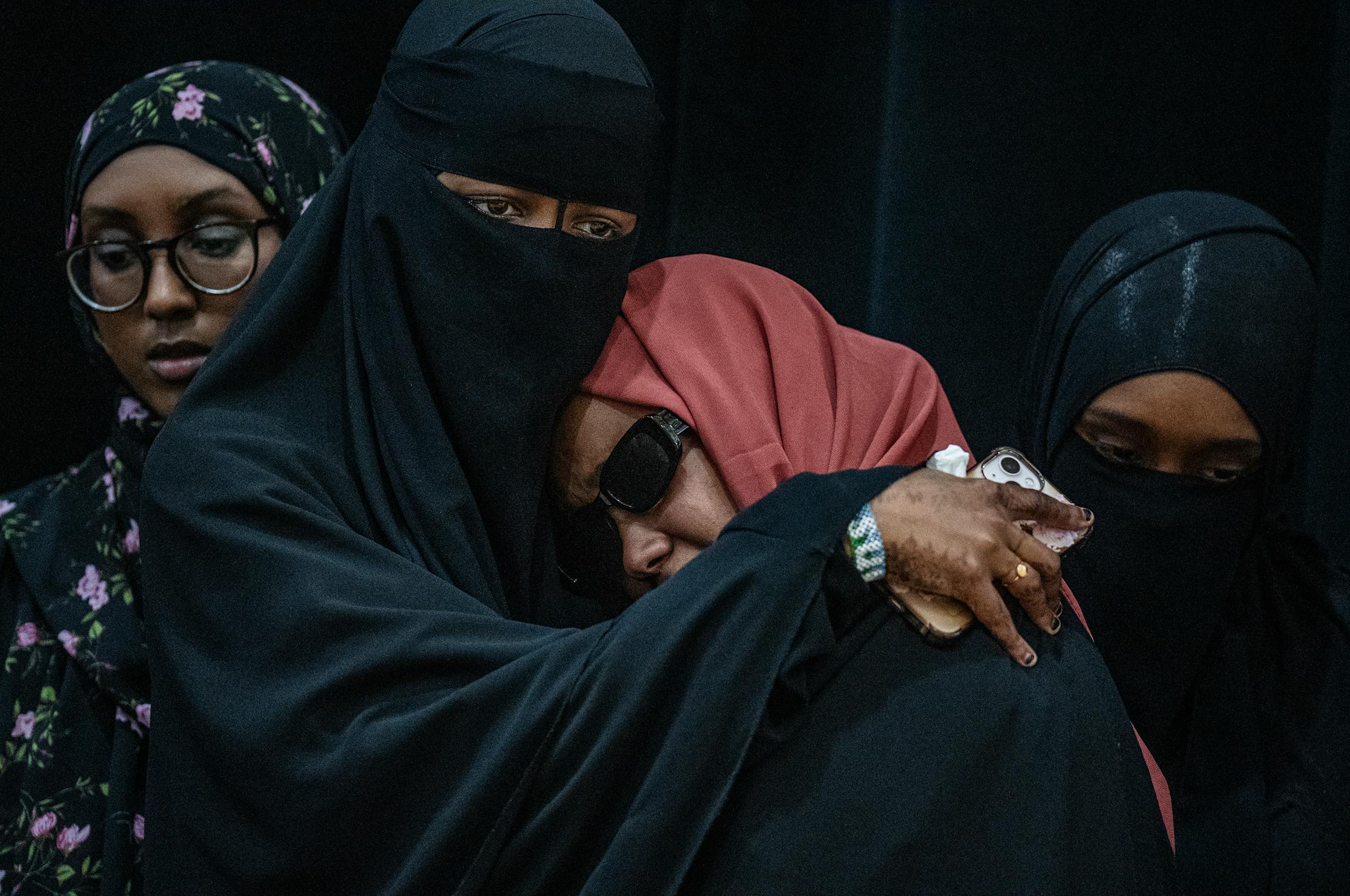 Sundus Adan Odhowa, left, comforts Sundus Mohamoud Ali(red) as they speak at a press conference calling for an independent investigation of a crash that killed five loved ones in Bloomington, Minn., on Monday, June 26, 2023. CAIR-MN is calling for an independent investigation of the crash that killed five in Minneapolis.