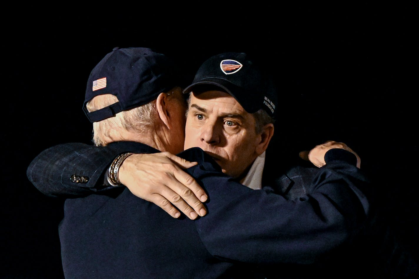 FILE — President Joe Biden hugs his son Hunter before departing Dover Air Force Base after a trip together in Ireland, April 14, 2023. The possibility of a federal indictment of Hunter Biden has left President Biden stunned. Yet the bond between the president and his only surviving son is ironclad. (Kenny Holston/The New York Times)