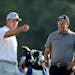 Bryson DeChambeau, left, talks with Phil Mickelson on the 10th tee during a practice round for the Masters