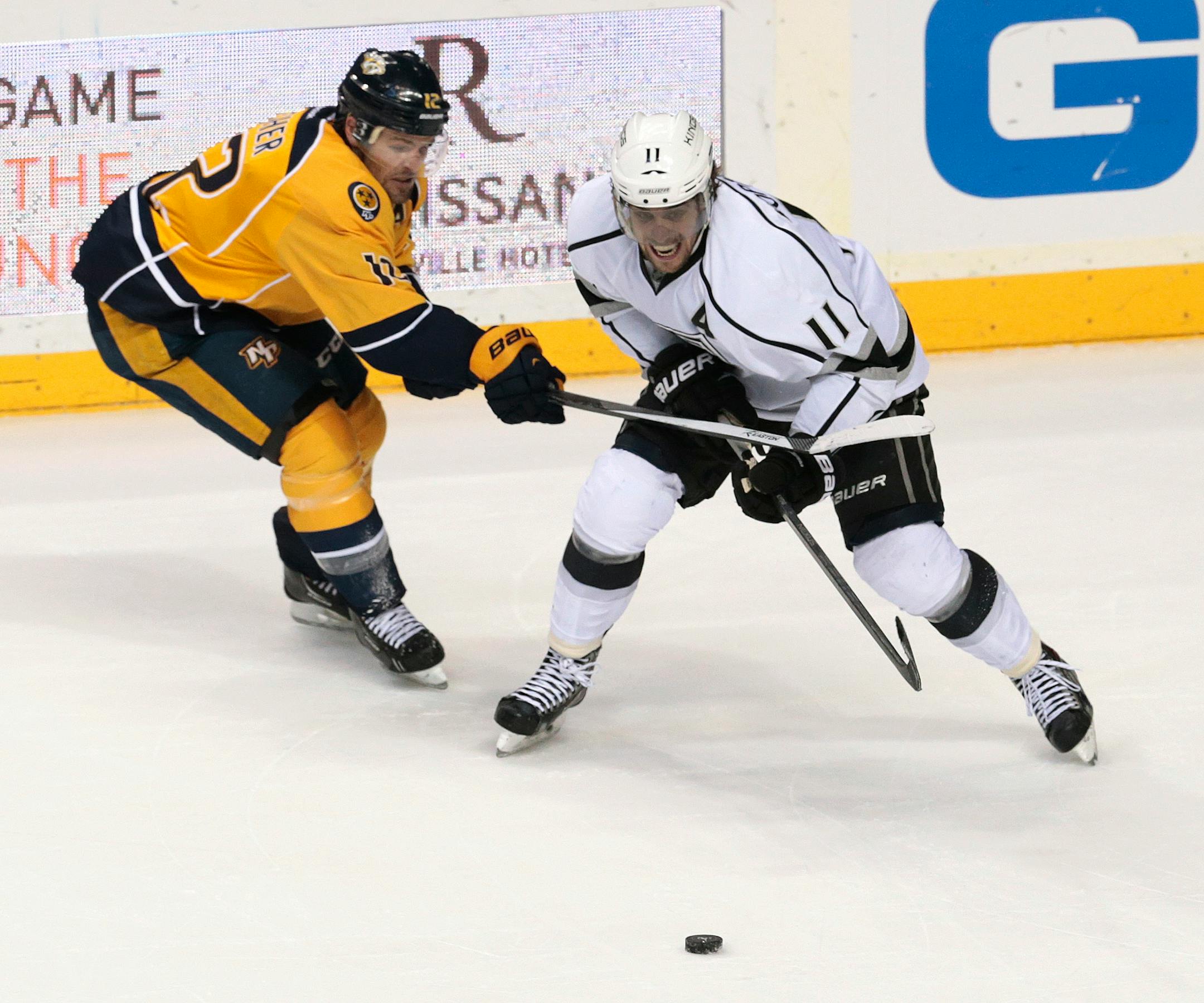 Nashville Predators forward Mike Fisher (12) tries to keep Los Angeles Kings center Anze Kopitar (11), of Slovenia, off the puck during the second period of an NHL hockey game Saturday, Dec. 28, 2013, in Nashville, Tenn. (AP Photo/Mark Humphrey)
