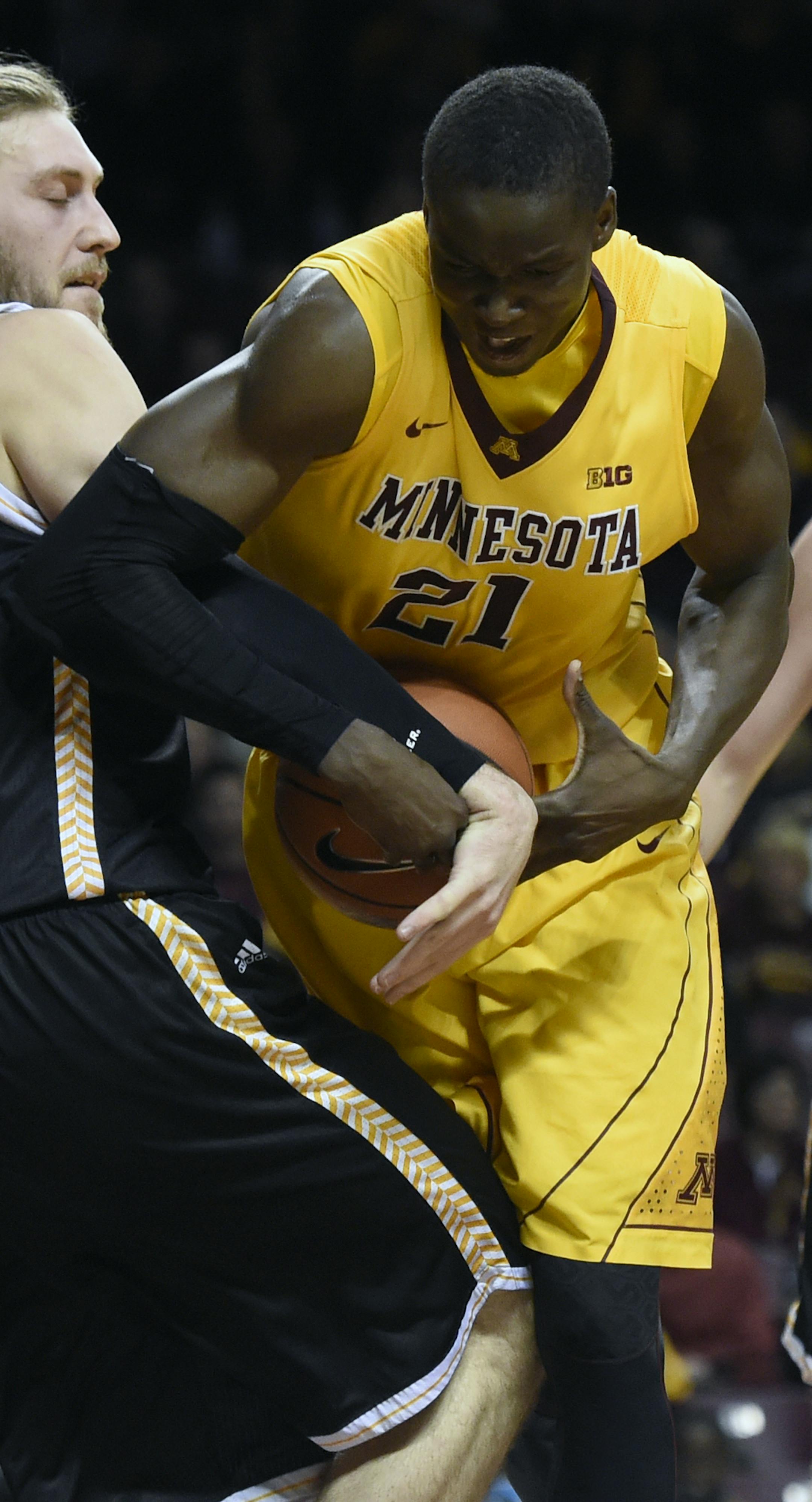 Milwaukee forward Matt Tiby (31) fouls Minnesota center Bakary Konate (21) during the second half of an NCAA college basketball game Wednesday, Dec. 23, 2015, in Minneapolis. Milwaukee won 74-65. (AP Photo/Hannah Foslien) ORG XMIT: MIN2016010119220629