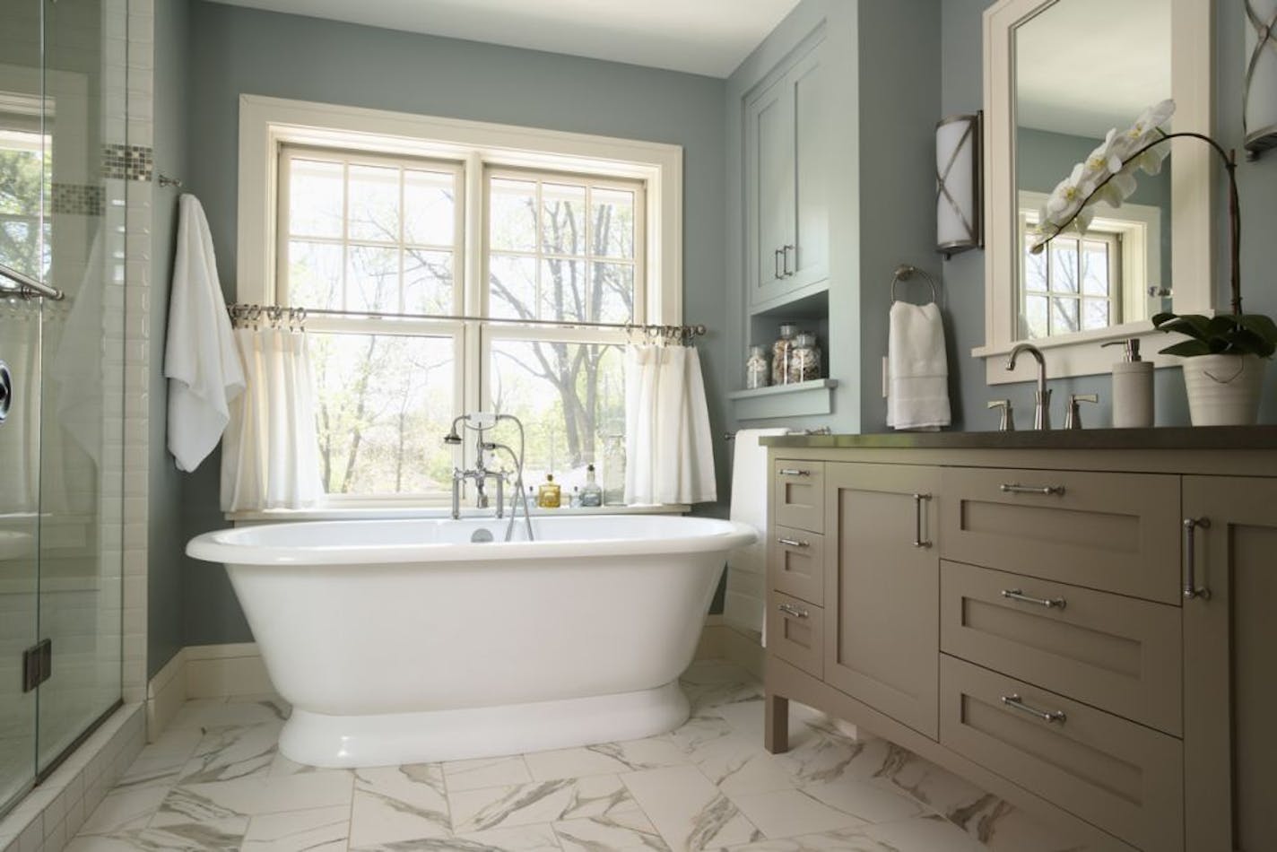 Spa-like master baths with deep soaking tubs are still sought after. The furniture-style vanity is topped with quartz, which is easier to clean. "This look and feels timeless and will last longer," said designer Lisa Peck of Lilu Interiors in Minneapolis.