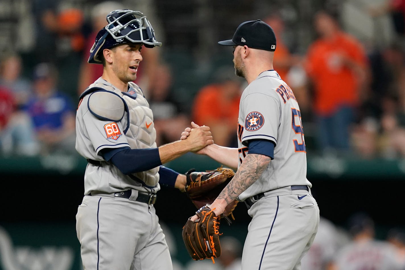 Houston Astros closer Ryan Pressly (55) is congratulated by catcher Jason Castro after the team's win over the Texas Rangers in a baseball game in Arlington, Texas, Tuesday, June 14, 2022. (AP Photo/LM Otero)