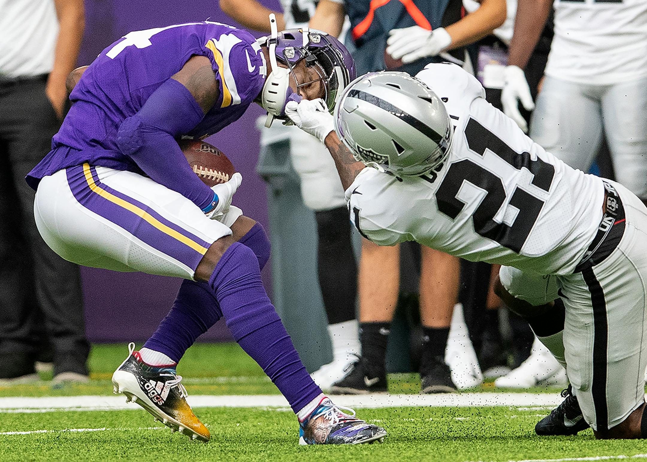 Oakland Raiders' Gareon Conley (21) grabbed the face mask of Minnesota Vikings' Stefon Diggs (14) in the first quarter.