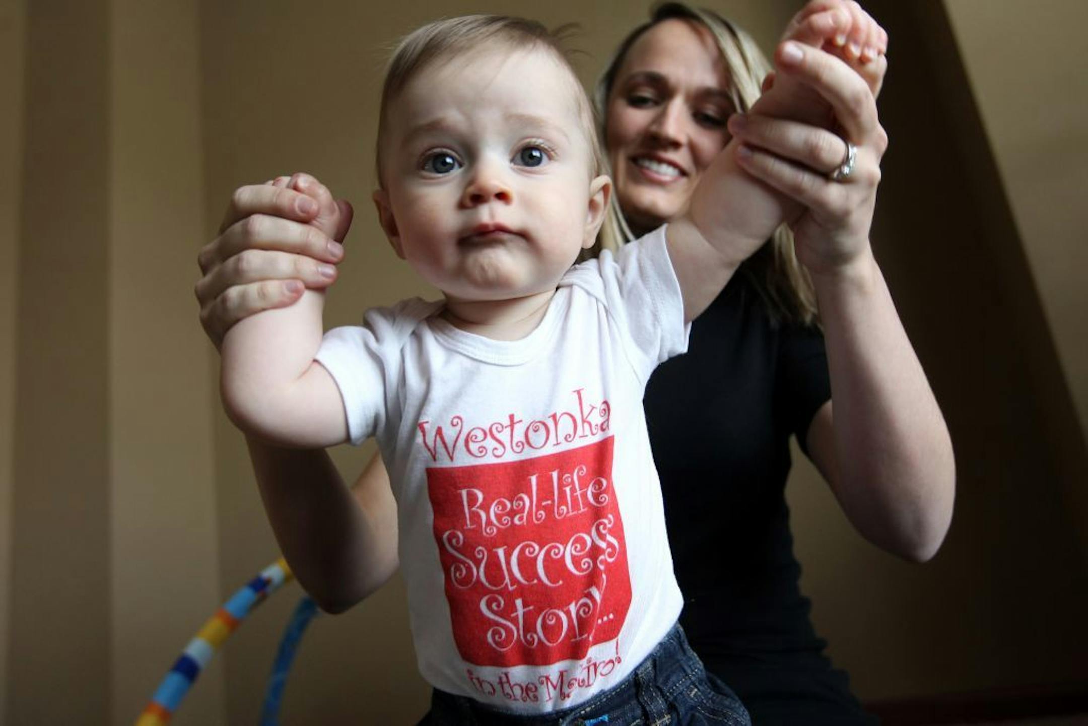 Minnetrista parent Christine Charlson lives in the Waconia School District and signed up her newborn son, Chase, for their classes. But when she received a baby bag from Westonka Schools promoting their early childhood classes, it prompted her to sign up for Westonka's classes this year, too. The Westonka onesie that Chase, 7 months, is wearing was included in that gift bag. Photographed at their home in Minnetrista January 13, 2012.
