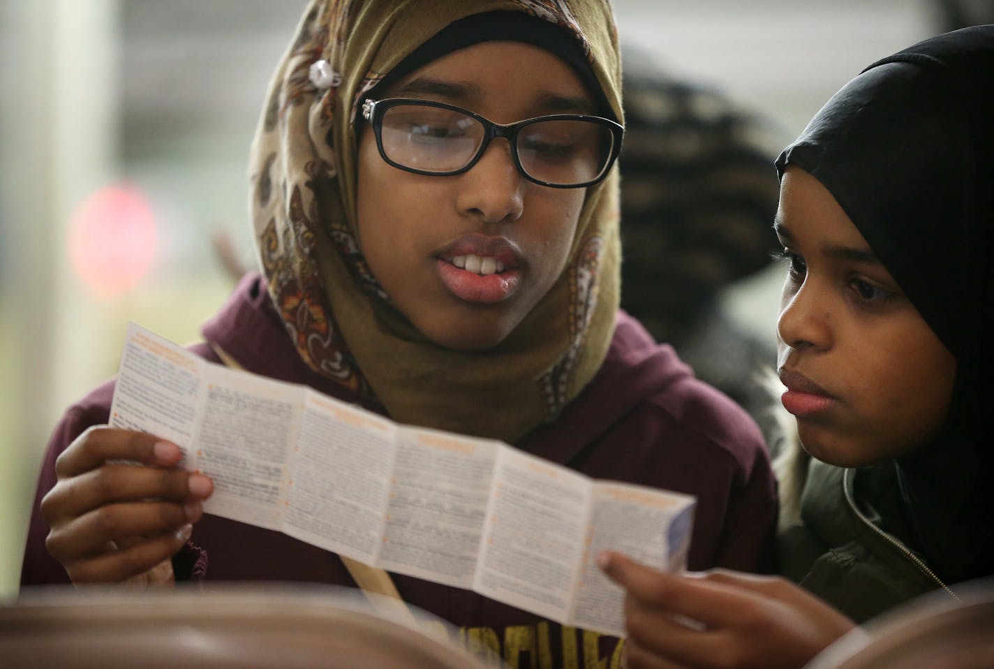 Sumaya Hanafi left,and her sister Amina Hanafi read over a pamphlet "know your rights and responsibilities as an American Muslim" during a information meeting at CAIR-MN Tuesday January 31, 2017 in Minneapolis, MN.] CAIR-MN went over your rights as a traveler, immigrant and refugee in light of the recent presidential executive order regarding the ban of Muslims at the American border. JERRY HOLT &#xef; jerry.holt@startribune.com