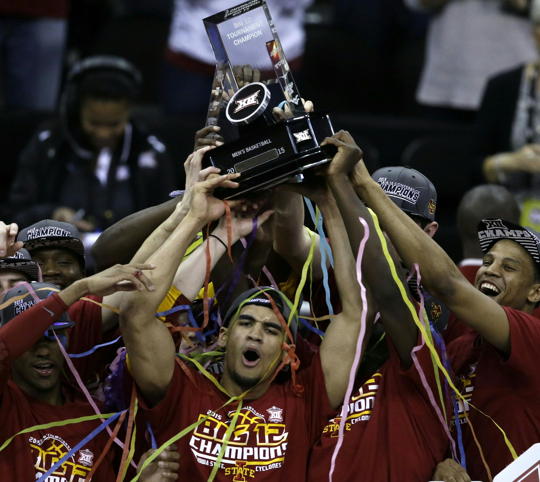 Iowa State basketball team holds up their championship trophy following an NCAA college basketball game against Kansas in the finals of the Big 12 Conference tournament in Kansas City, Mo., Saturday, March 14, 2015. Iowa State defeated Kansas 70-66. (AP Photo/Orlin Wagner)