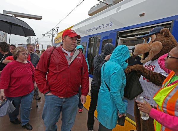 The public and dignitaries boarded the first Green Line train to leave Target Field Station on 6/14/14. Twins mascot TC was on hand for the opening.]