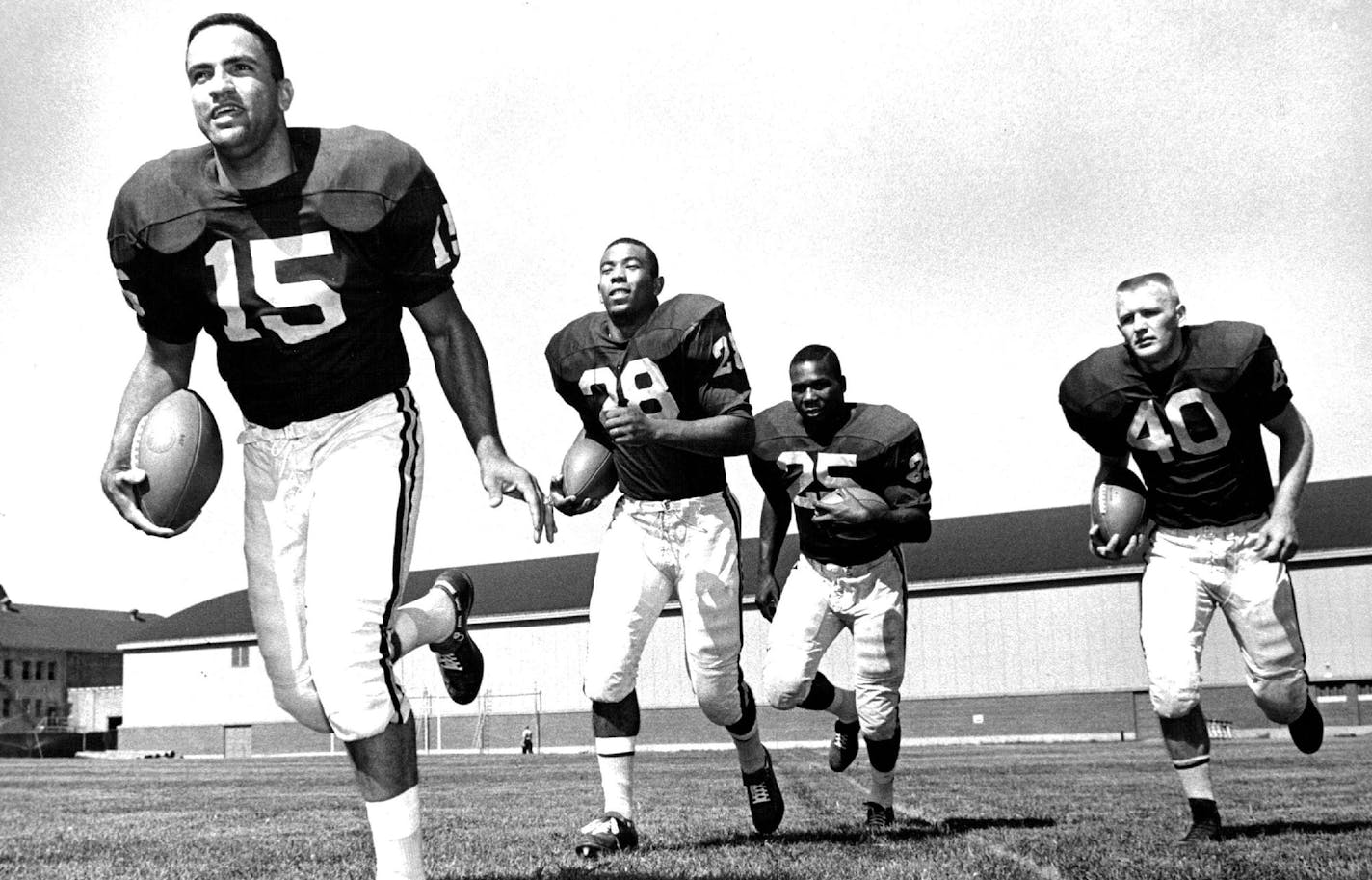 September 1, 1961 Gopher Backfield-Sandy Stephens, Bill Munsey, Judge Dickson And Dave Mulholland Veteran of 1960 National championship team ran for cameramen Thursday August 31, 1961 John Croft, Minneapolis Star Tribune