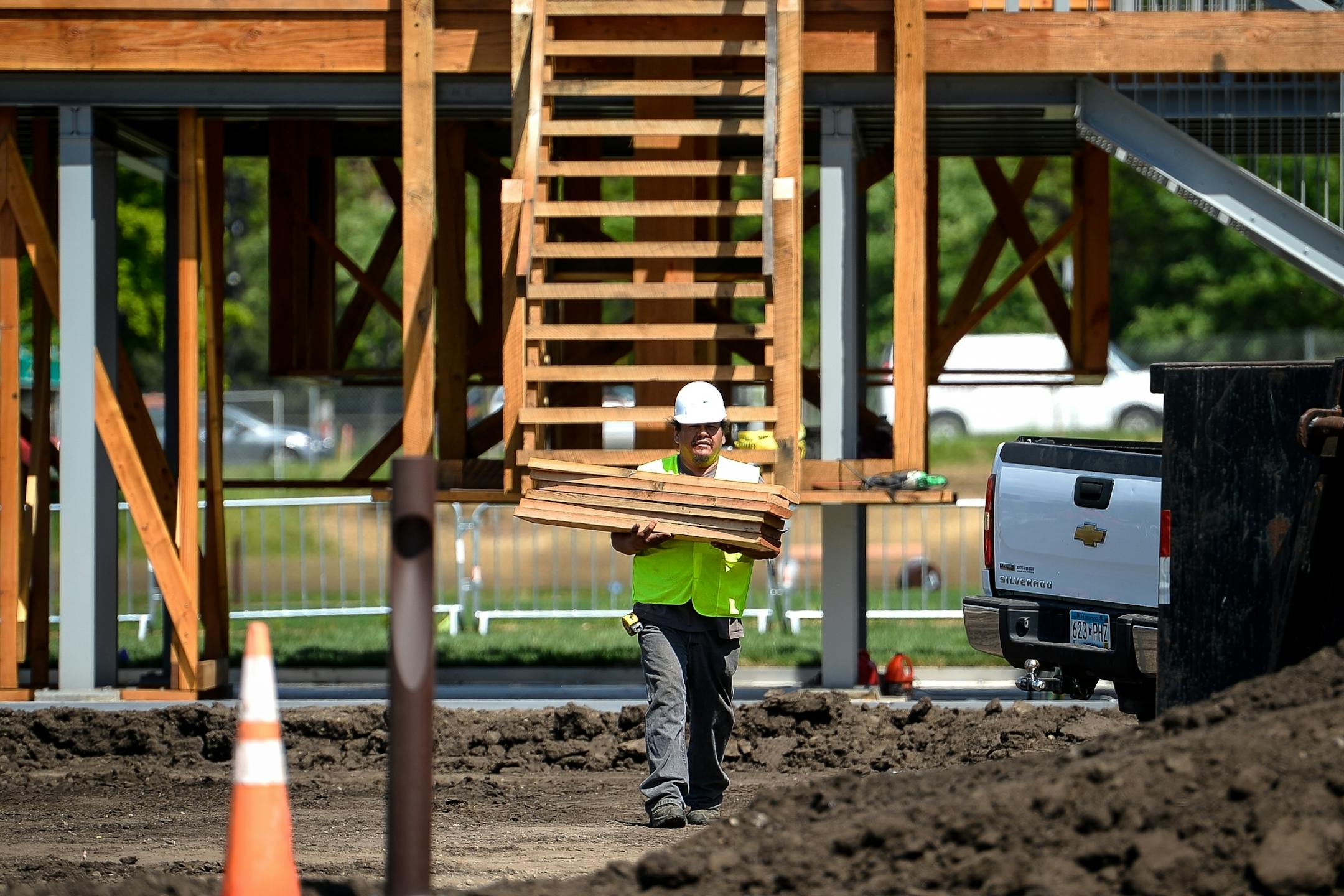 Brian LaBatte, a Lakota and Dakota from Cheyenne River, walked pieces of wood removed from the "Scaffold" Sculpture to a dumpster during the sculpture's demolishment Friday.
