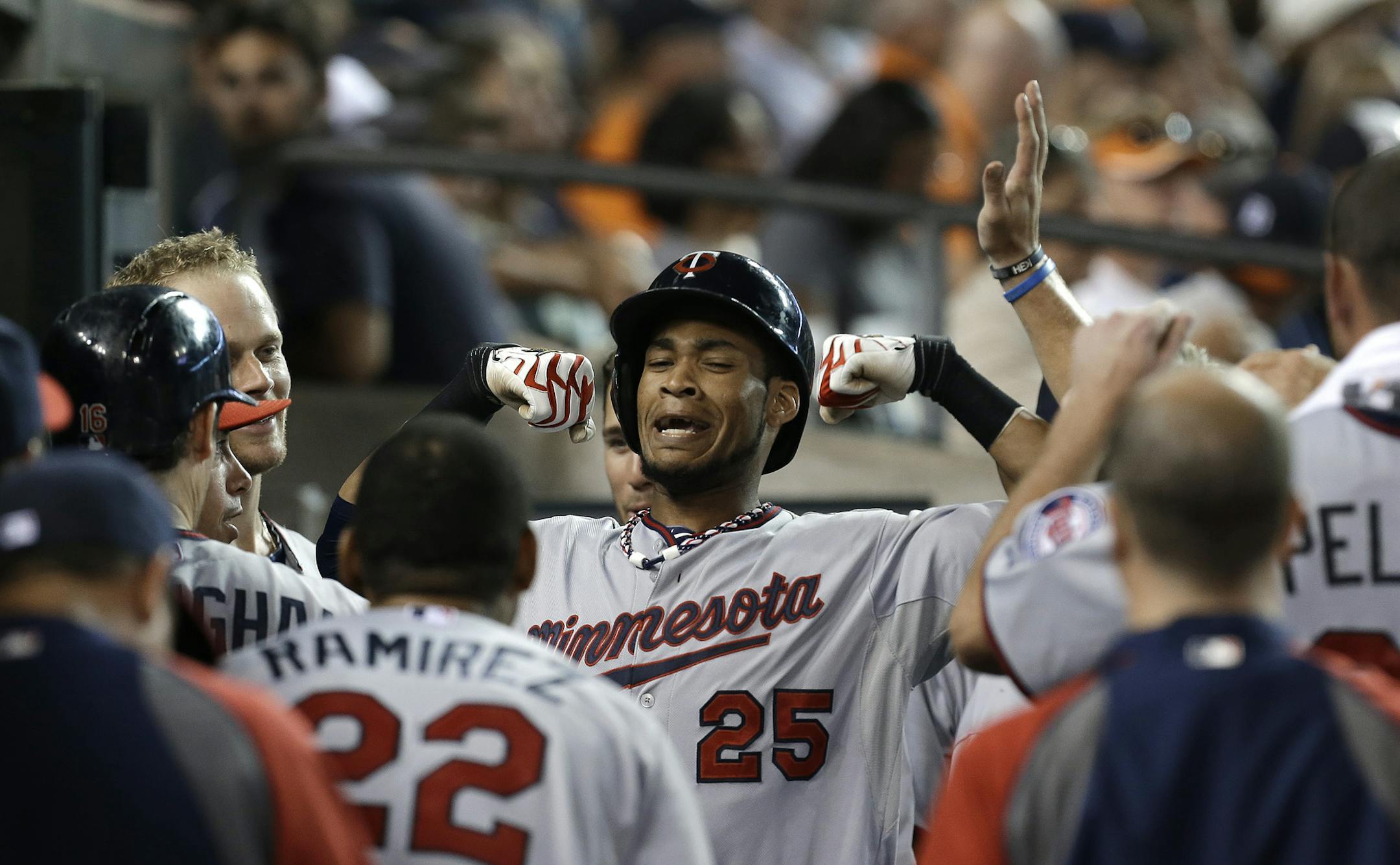 Minnesota Twins' Pedro Florimon flexes after hitting a solo home run against the Detroit Tigers in the sixth inning of a baseball game in Detroit, Tuesday, Aug. 20, 2013. (AP Photo/Paul Sancya)