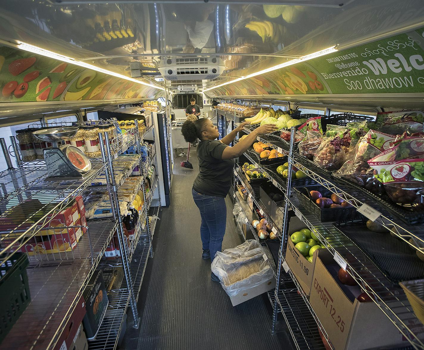 Mobile Market driver/cashier Keshawn Williams stocked fruit on the bus.