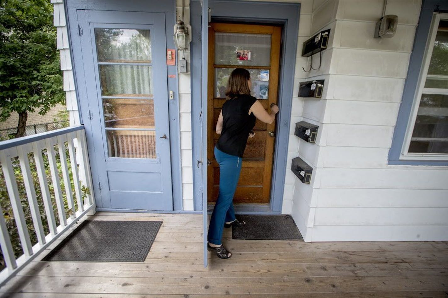 Minneapolis resident Janne Flisrand on the front porch of her fourplex. Minneapolis planners had proposed a long-range plan allowing fourplexes citywide, but are scaling that back after criticism.